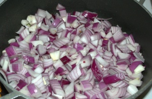 Red Onion getting roasted in edible oil